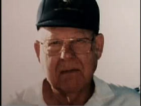 Charles Baker in a hat, galsses and polo shirt