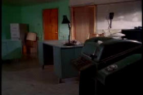 Basement with a cabinet, desk, lamp and office supplies