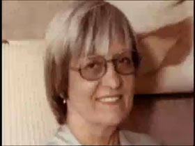 Opal Zacharias smiling and wearing glasses