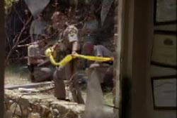 Forest service ranger pulling yellow crime scene tape around the sight of a bombing