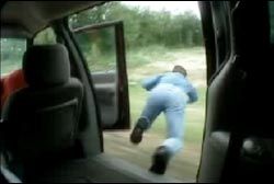 A man jumping out of a moving mini-van