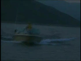 Styarfyr at the helm of a small boat on Snake River