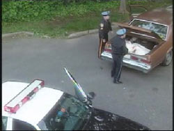 Two police investigators finding Nancy and Billy's body in the trunk of an abandoned car